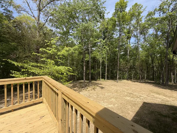 a view of a house with wooden fence