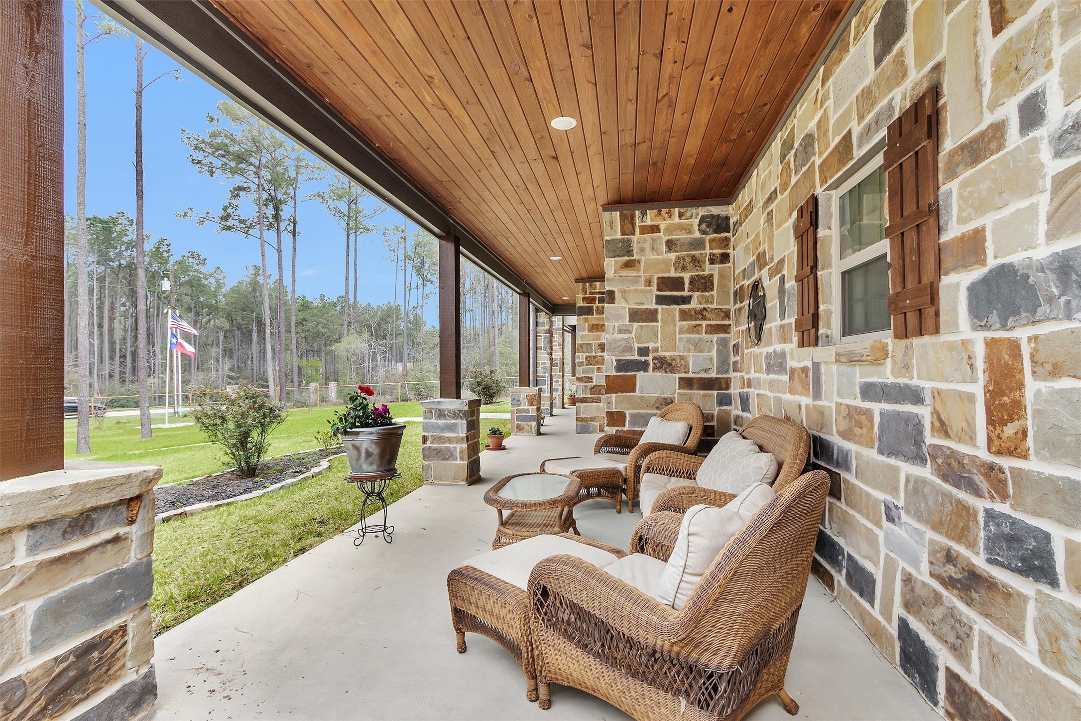 264 Grey Feather Road Huntsville, TX 77340 - Photo 3 of 31 Covered front porch with natural stone exterior and relaxing seating area