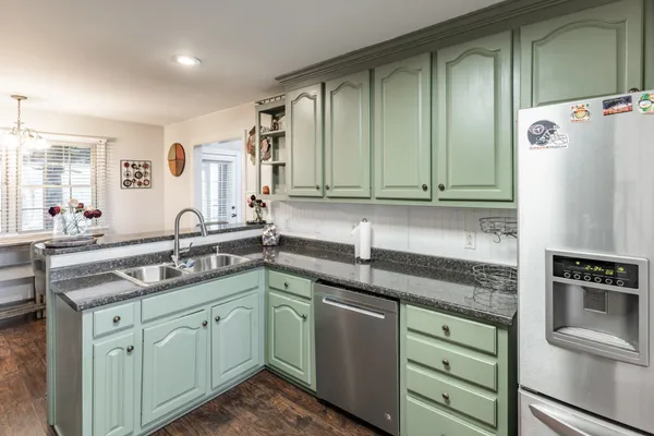 a kitchen with stainless steel appliances granite countertop a sink stove and refrigerator