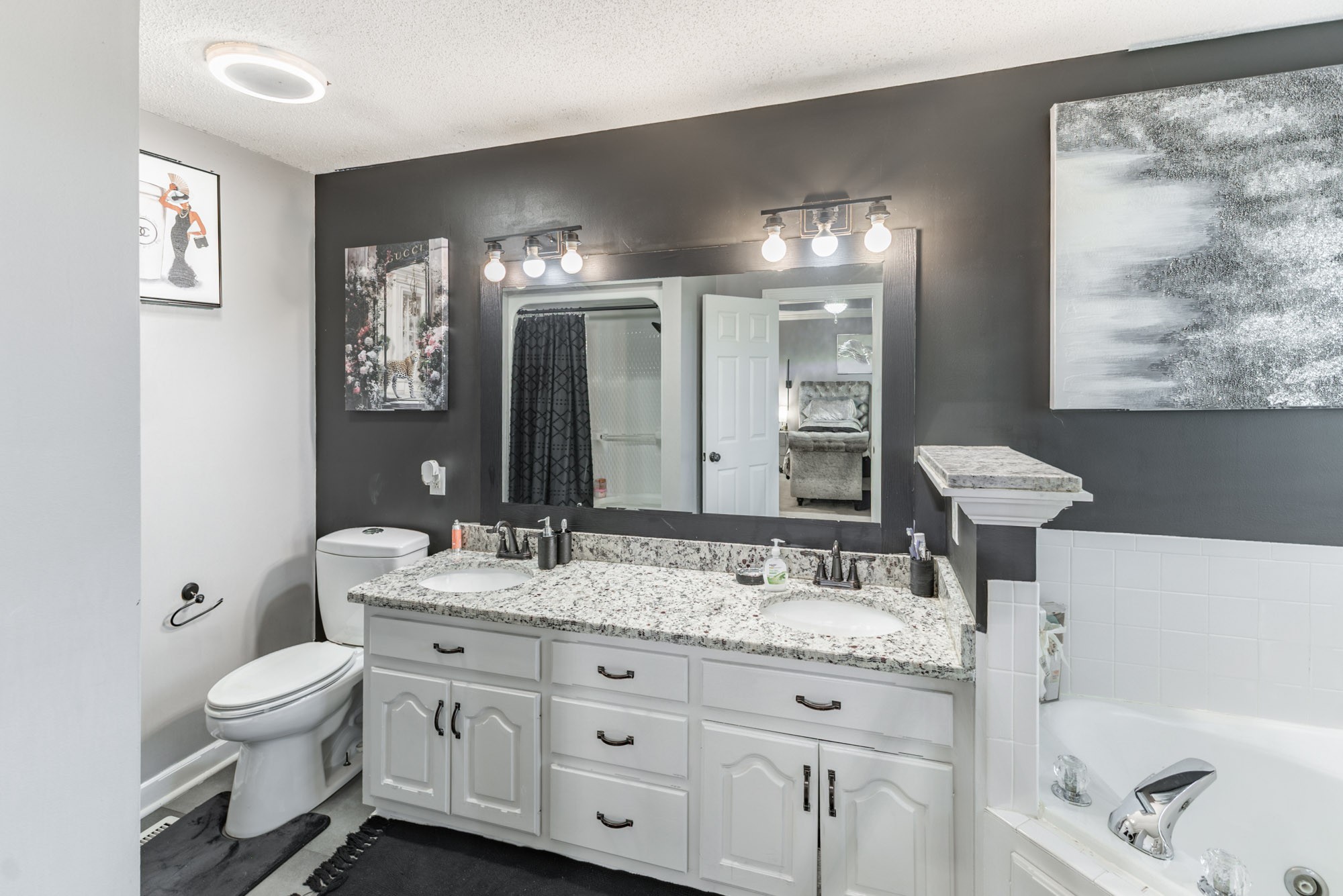 61 Eastridge Road Fayetteville, TN 37334 - Photo 20 of 42 a bathroom with a granite countertop sink toilet and painting on the wall