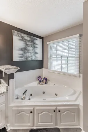 a bathroom with a bathtub and a sink