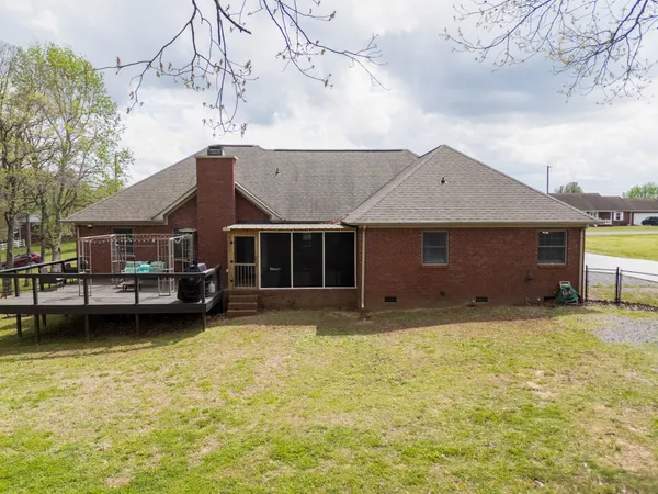 a view of house with patio outdoor seating and wooden floor
