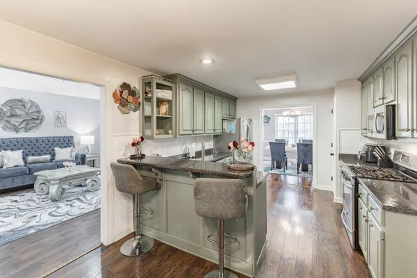 a kitchen with stainless steel appliances granite countertop a stove and a refrigerator