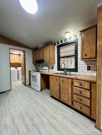a kitchen with stainless steel appliances kitchen island granite countertop a stove a sink and a microwave
