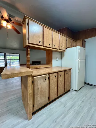 a kitchen with stainless steel appliances a stove a refrigerator a sink and a microwave