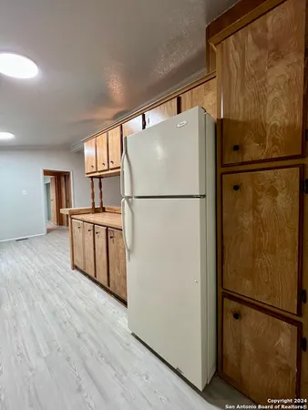 a white refrigerator freezer and a dishwasher sitting in a kitchen