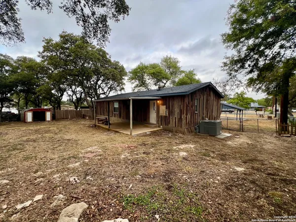 a view of a house with a yard and tree