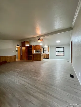 a view of a room with wooden floor