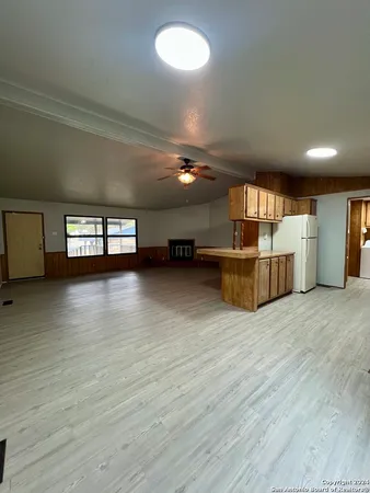 a view of a room with wooden floor