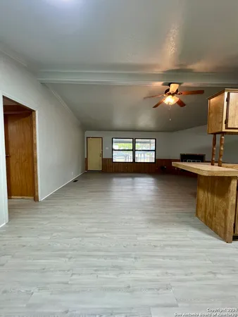 a view of a room with wooden floor