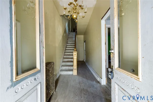 a view of staircase with wooden floor and white walls