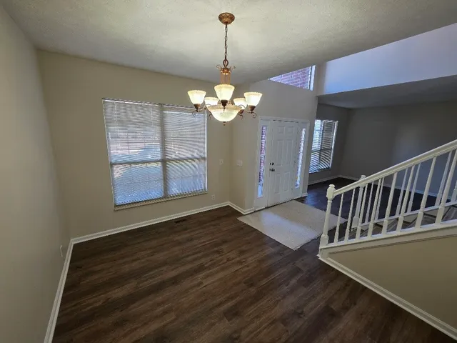 a view of an entryway with wooden floor