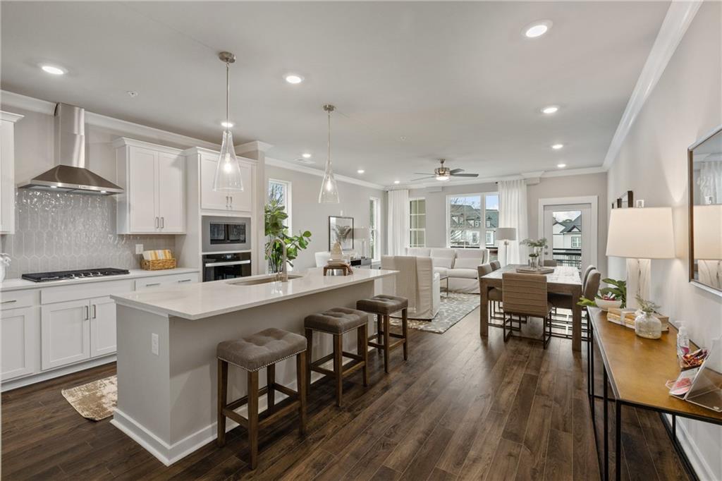 a large kitchen with stainless steel appliances lots of counter space and wooden floor
