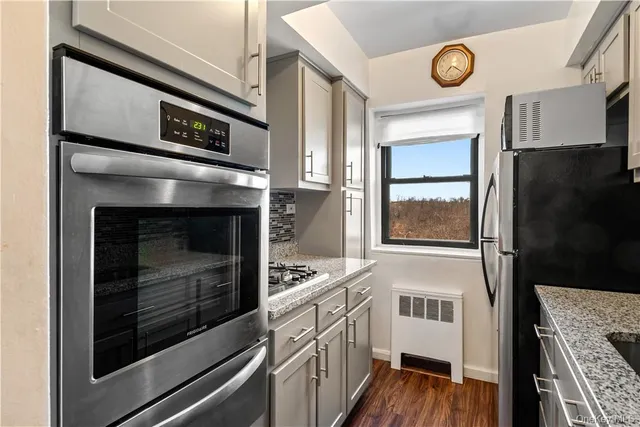 a kitchen with stainless steel appliances a stove a microwave and a refrigerator