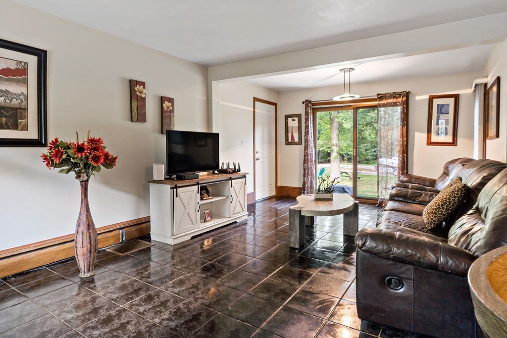 16 Martin Street Rehoboth, MA 02769 - Photo 13 of 38 a living room with furniture a flat screen tv and a floor to ceiling window