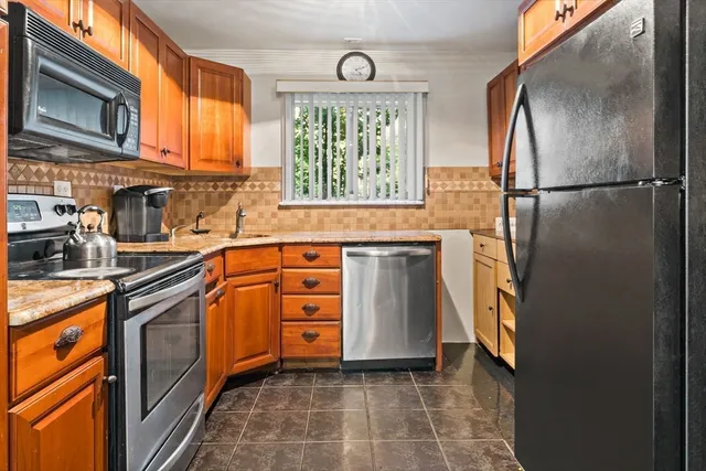 a kitchen with stainless steel appliances granite countertop a refrigerator sink and cabinets