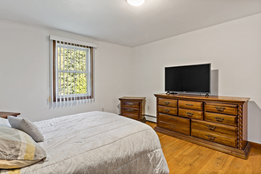 16 Martin Street Rehoboth, MA 02769 - Photo 26 of 38 a bedroom with a bed and a flat screen tv