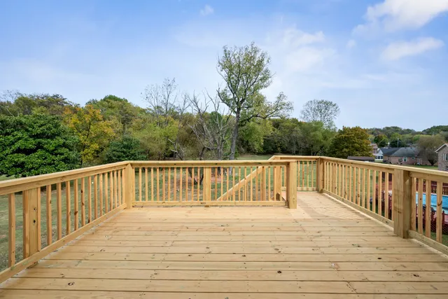 a view of balcony with wooden floor and fence
