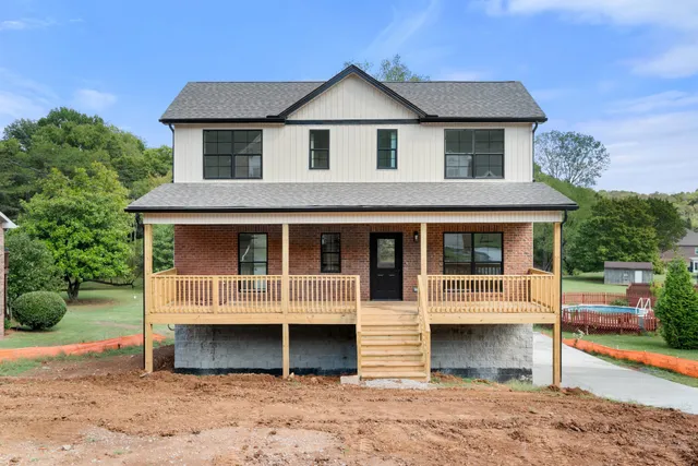 a view of backyard with barbeque oven and wooden fence