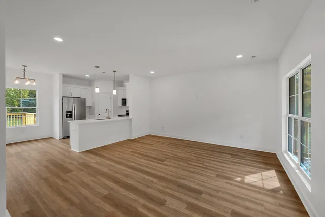 a view of kitchen with stainless steel appliances refrigerator oven and cabinets