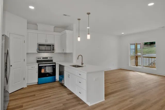 a kitchen with stainless steel appliances granite countertop a refrigerator and a sink