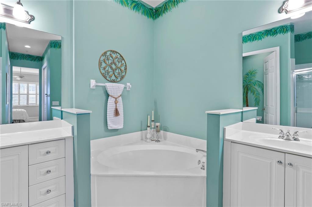 4541 Cardinal Cove Lane Naples, FL 34114 - Photo 11 of 42 a bathroom with a sink and a mirror