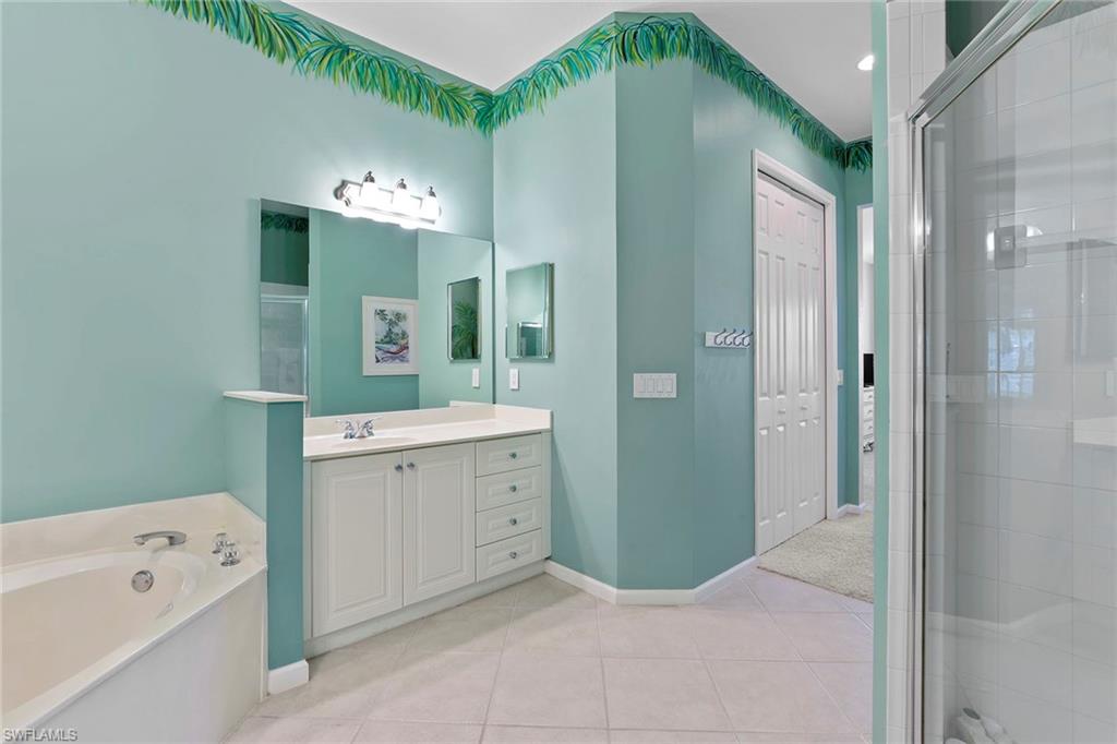 4541 Cardinal Cove Lane Naples, FL 34114 - Photo 12 of 42 a spacious bathroom with a double vanity sink mirror and shower