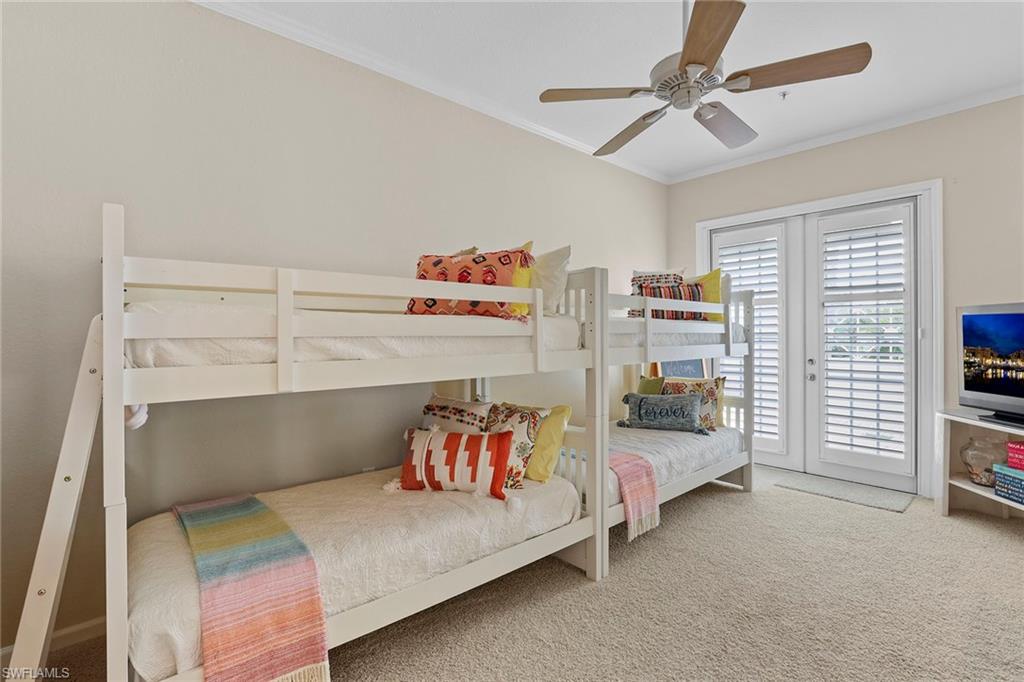 4541 Cardinal Cove Lane Naples, FL 34114 - Photo 13 of 42 a bedroom with furniture and a chandelier