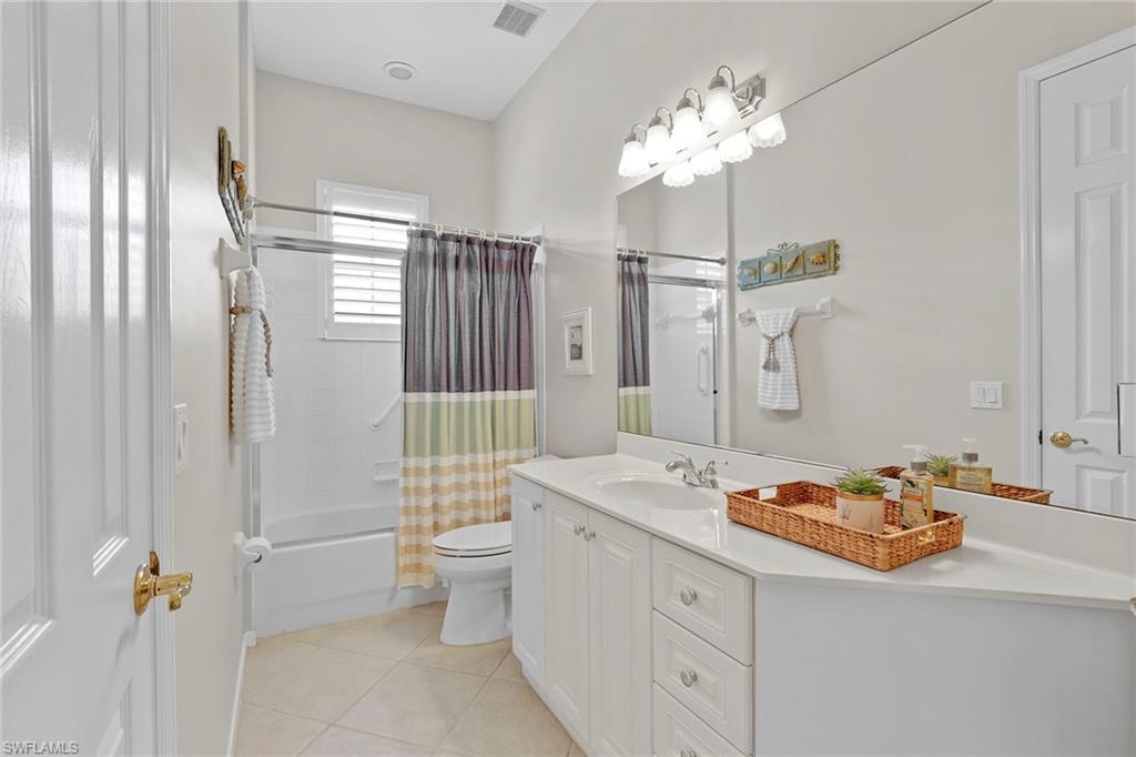 4541 Cardinal Cove Lane Naples, FL 34114 - Photo 14 of 42 a bathroom with a sink mirror and toilet