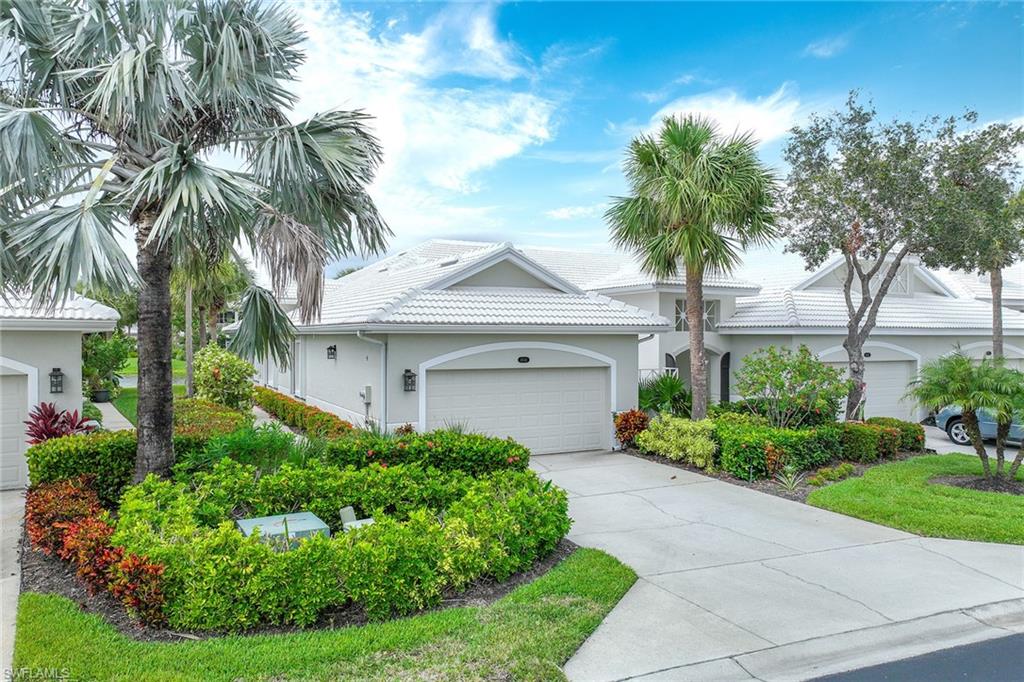 4541 Cardinal Cove Lane Naples, FL 34114 - Photo 20 of 42 a front view of a house with a garden