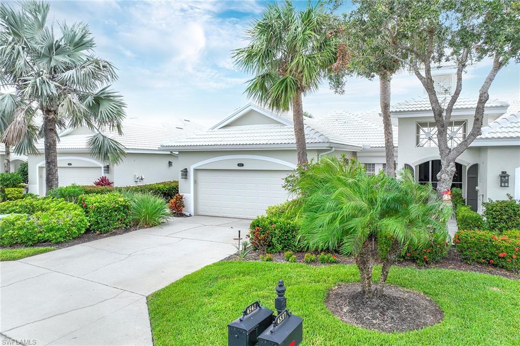 4541 Cardinal Cove Lane Naples, FL 34114 - Photo 21 of 42 a front view of a house with a yard and palm trees