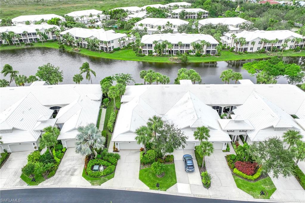 4541 Cardinal Cove Lane Naples, FL 34114 - Photo 22 of 42 an aerial view of residential houses with outdoor space and lake view