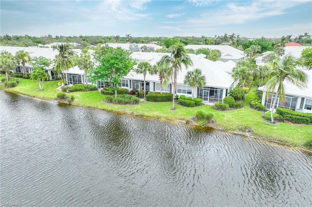4541 Cardinal Cove Lane Naples, FL 34114 - Photo 26 of 42 a view of a house with a yard and lake view