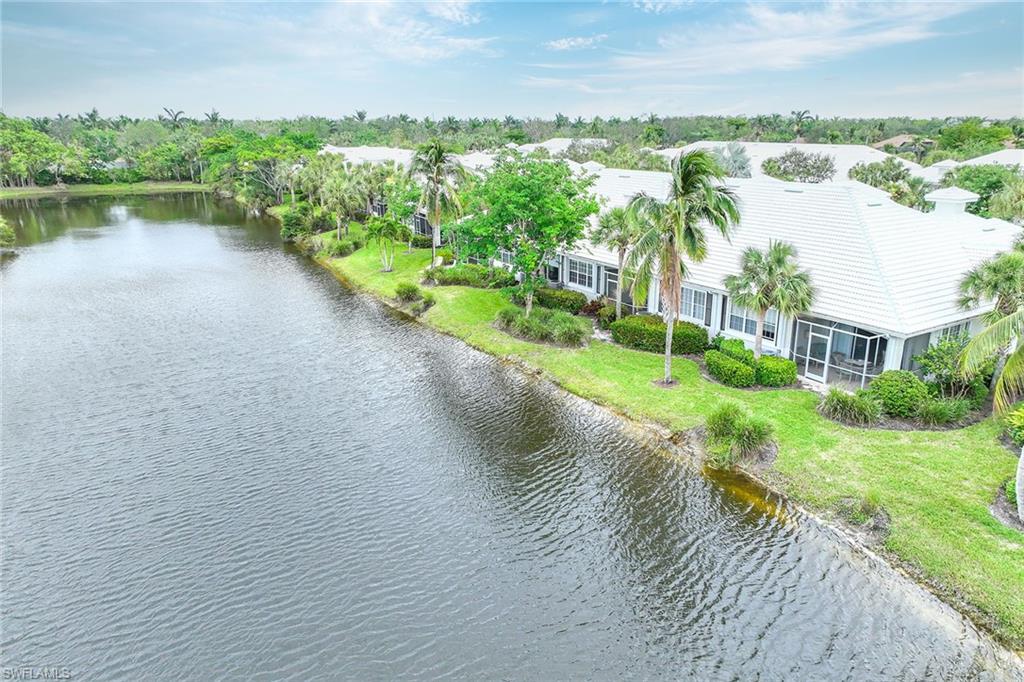 4541 Cardinal Cove Lane Naples, FL 34114 - Photo 27 of 42 a view of a lake with a yard