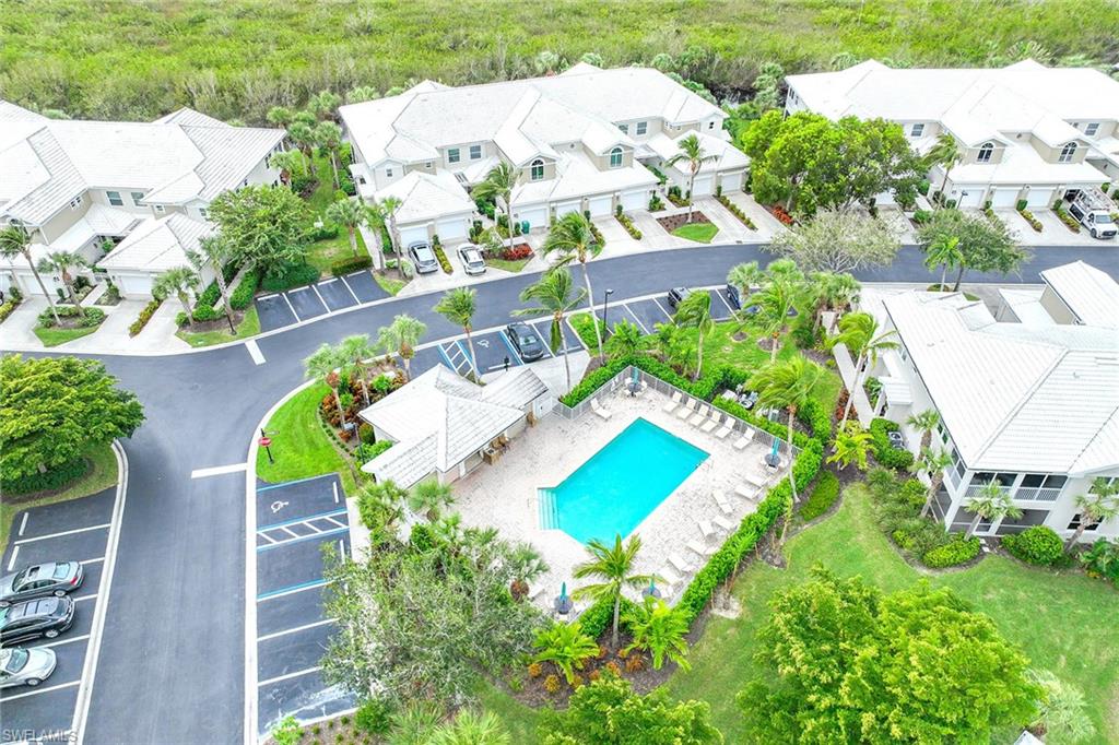 4541 Cardinal Cove Lane Naples, FL 34114 - Photo 28 of 42 an aerial view of a house with a yard pool patio and lake view