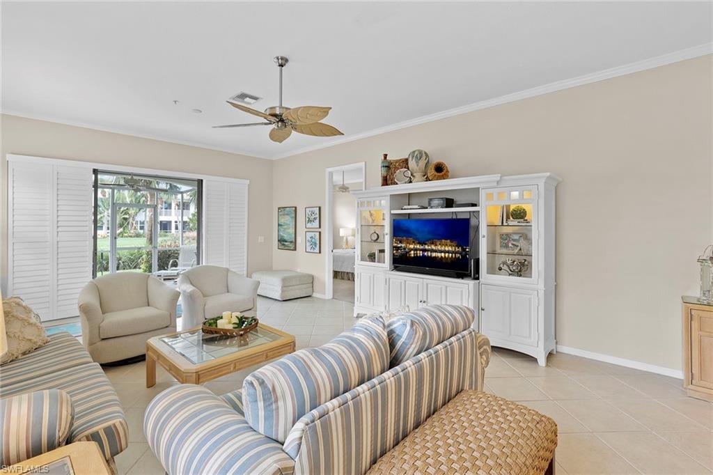 4541 Cardinal Cove Lane Naples, FL 34114 - Photo 3 of 42 a living room with furniture and a flat screen tv