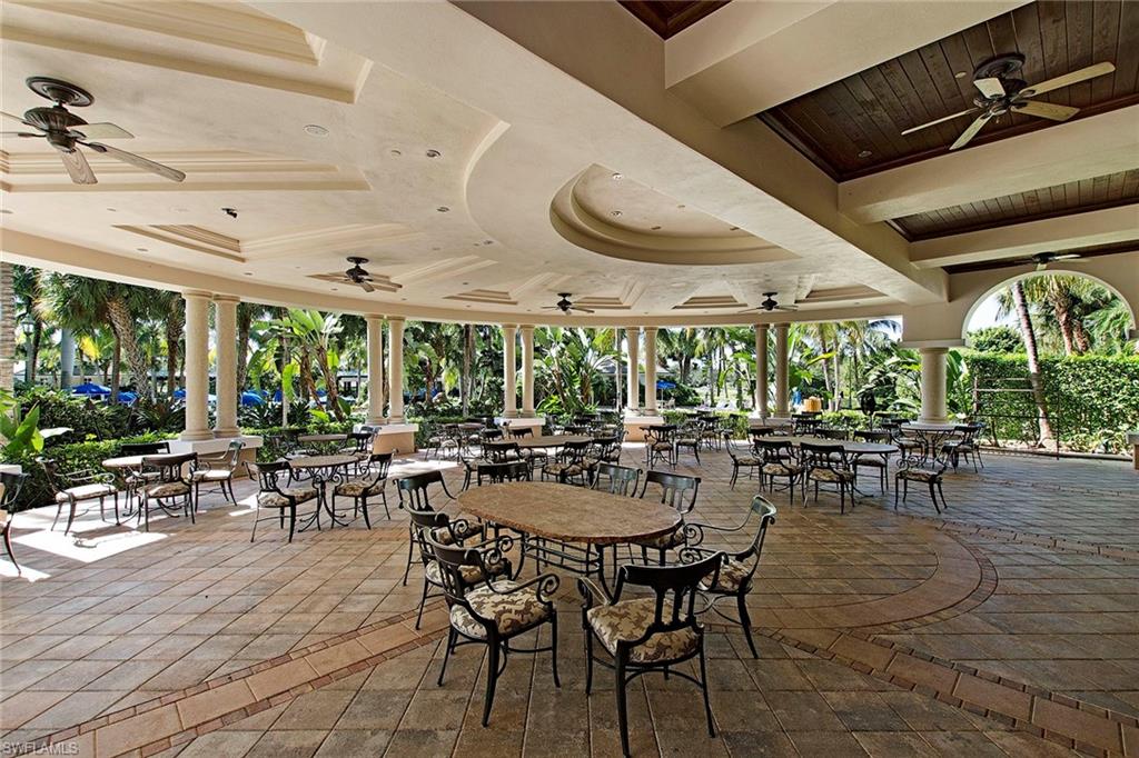 4541 Cardinal Cove Lane Naples, FL 34114 - Photo 41 of 42 a outdoor space with lots of tables a large window and chairs