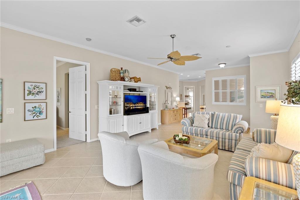 4541 Cardinal Cove Lane Naples, FL 34114 - Photo 5 of 42 a living room with furniture and a flat screen tv
