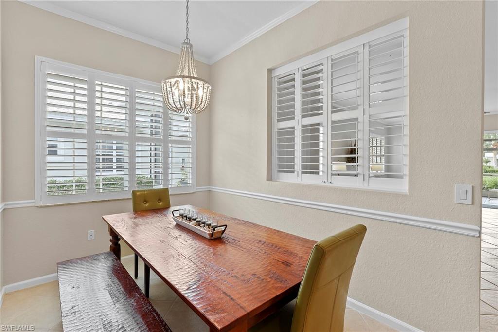 4541 Cardinal Cove Lane Naples, FL 34114 - Photo 6 of 42 a view of a dining room with furniture and windows