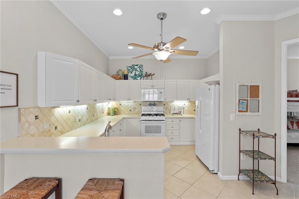 4541 Cardinal Cove Lane Naples, FL 34114 - Photo 7 of 42 a view of kitchen with furniture and chandelier