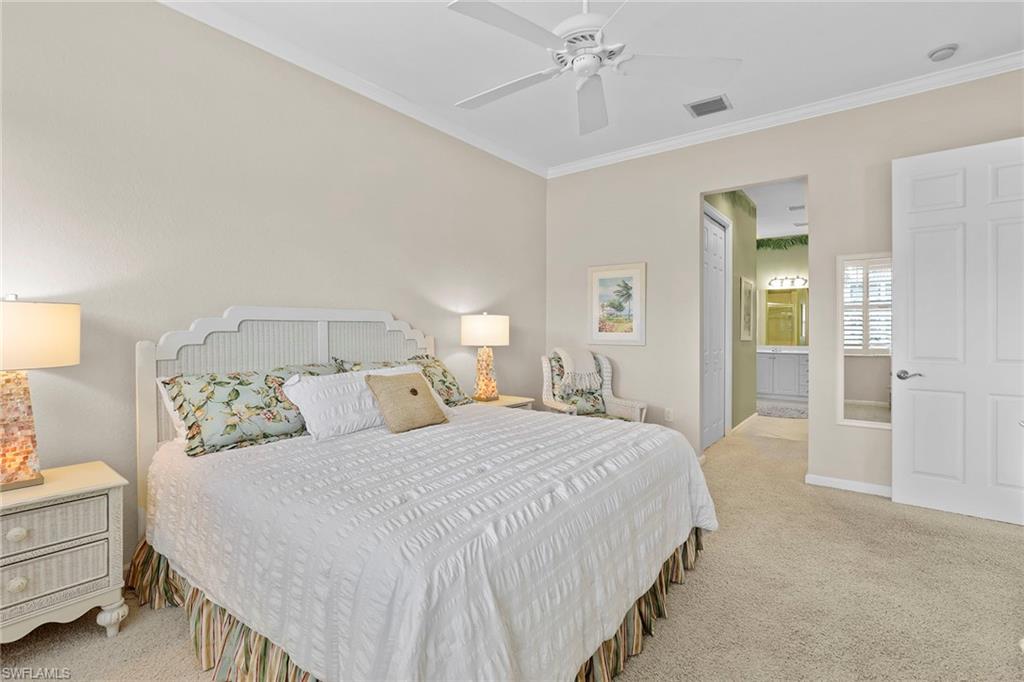 4541 Cardinal Cove Lane Naples, FL 34114 - Photo 10 of 42 a bedroom with a bed and a lamp
