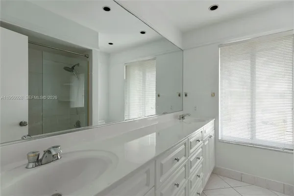 a bathroom with a tub sink and mirror