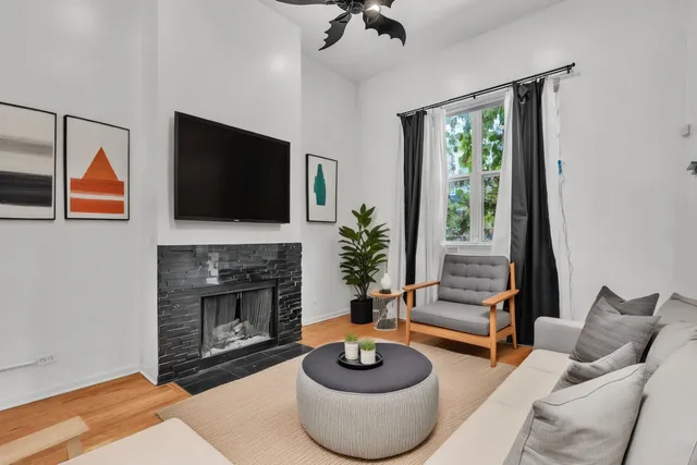 a living room with furniture a fireplace and a flat screen tv