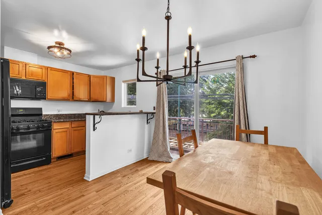 a kitchen with stainless steel appliances a stove top oven a sink and a wooden floor