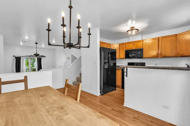 a kitchen with stainless steel appliances kitchen island sink refrigerator and microwave