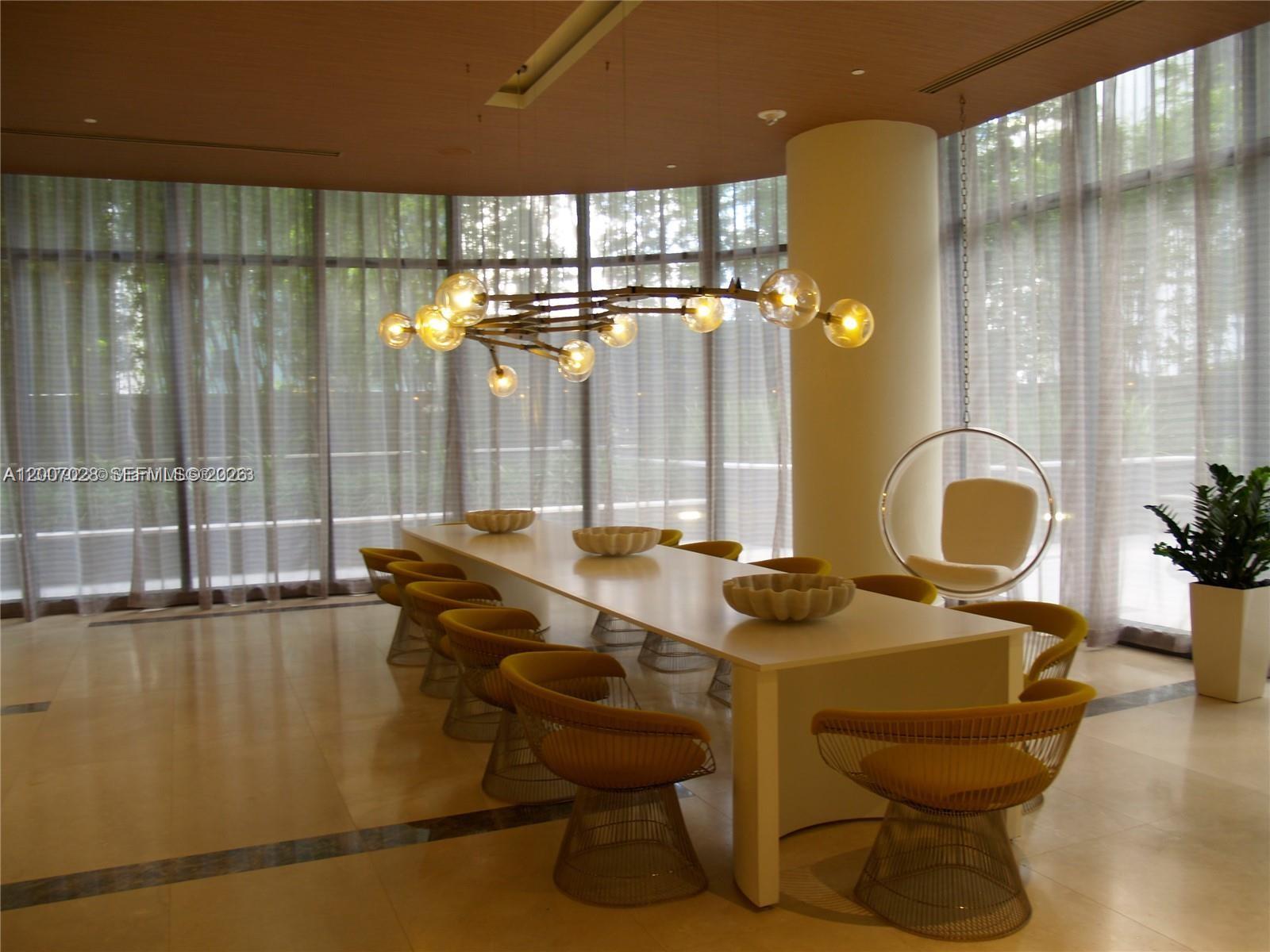 55 Southwest 9th Street, Unit 2502 Miami, FL 33130 - Photo 23 of 27 a room with a table and chairs