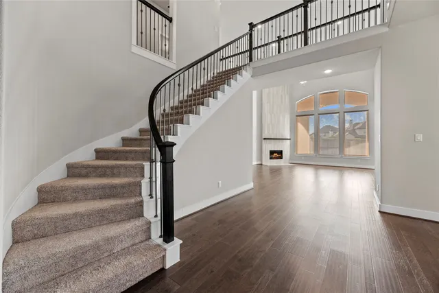 a view of entryway and hall with wooden floor
