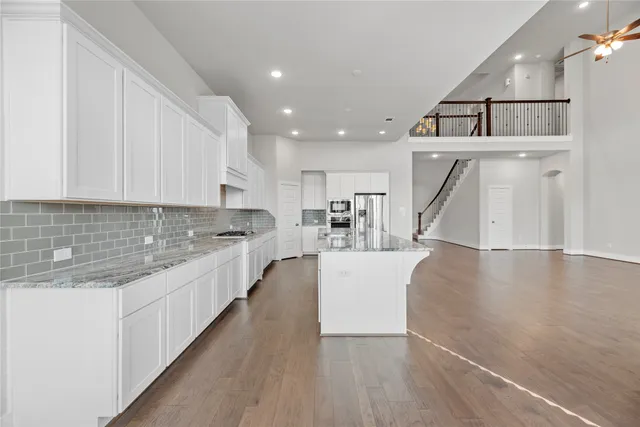 a view of kitchen with sink and refrigerator