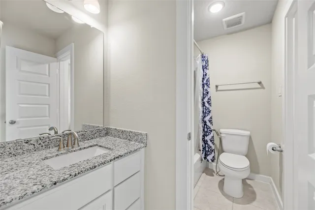 an empty room with a window and a kitchen