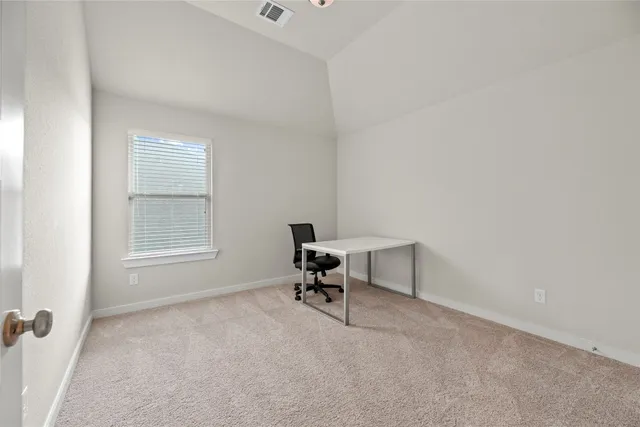a kitchen with white cabinets and a refrigerator